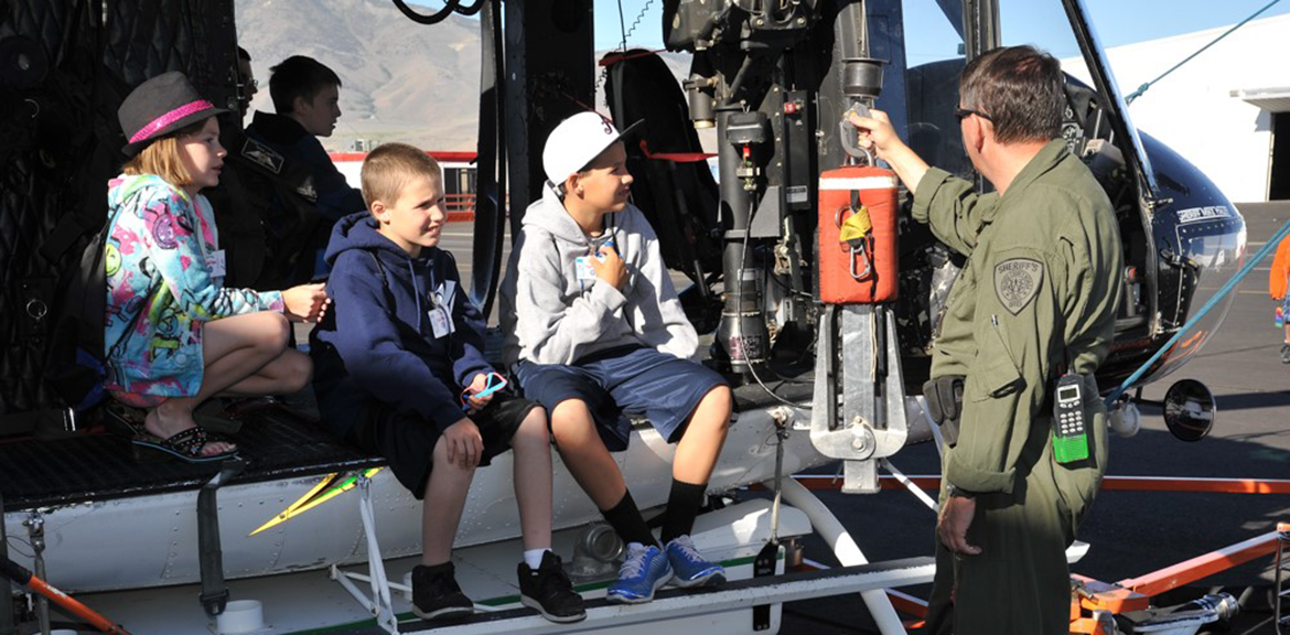 Three kids learning about helicopters, image courtesy of Pathways to Aviation