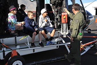 Three kids learning about helicopters, image courtesy of Pathways to Aviation