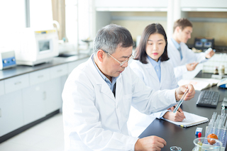 People conducting chemical experiment in modern lab